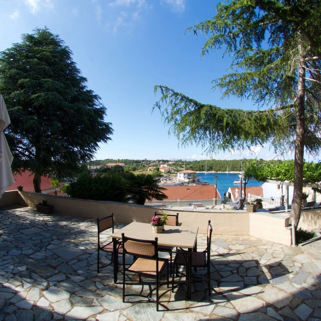 Shaded patio seating area at Porto Fiscardo apartments