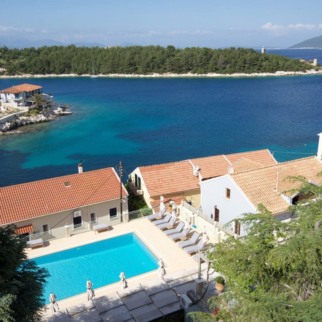Aerial view of Porto Fiscardo apartments and pool overlooking the Ionian Sea