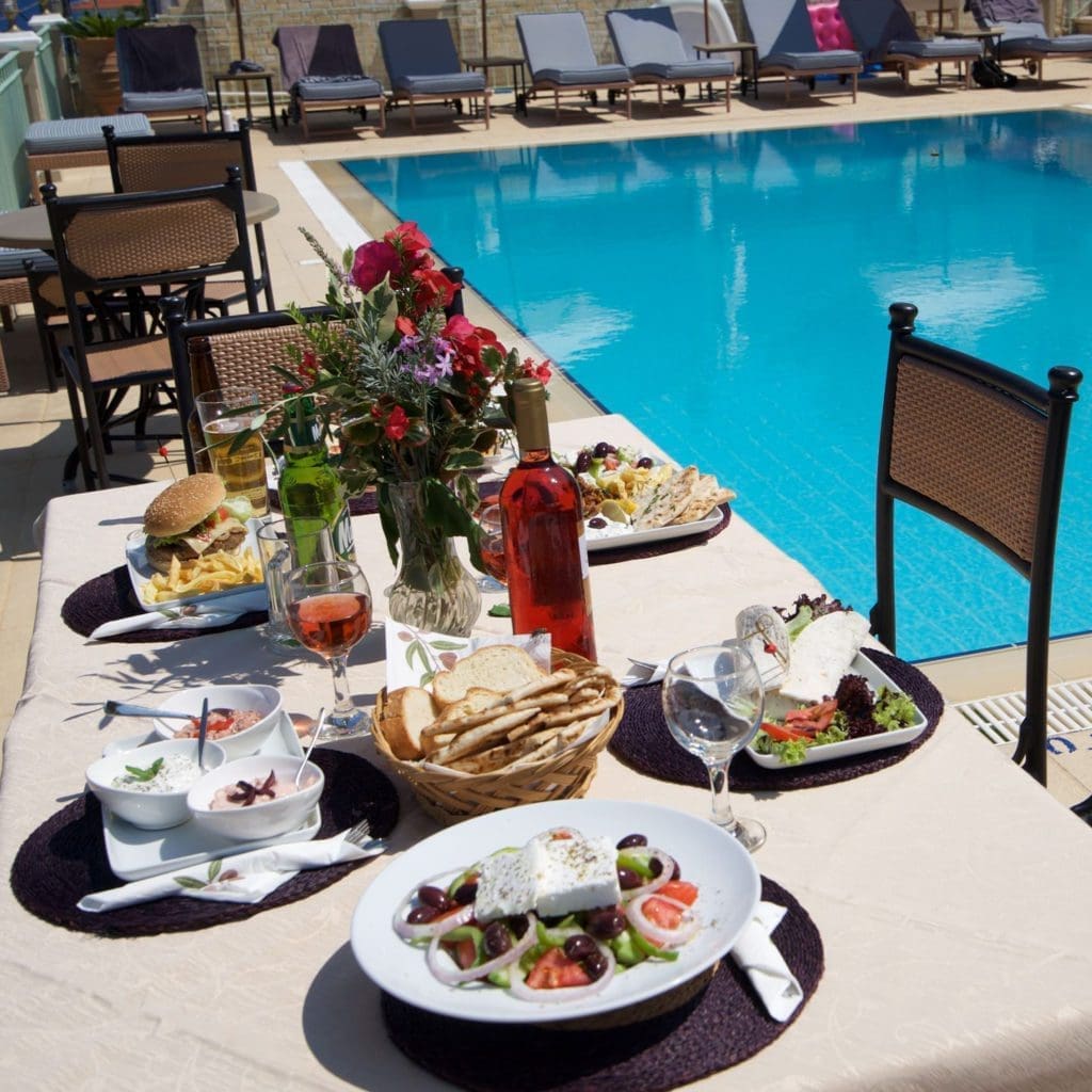 Mediterranean lunch table by the pool at Porto Fiscardo
