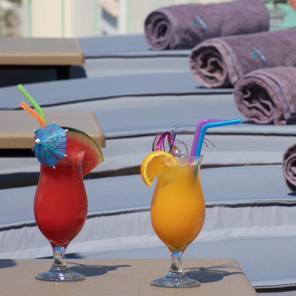 Colourful cocktails on balcony overlooking the sea in Fiskardo Kefalonia